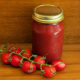 sugar-free fermented ketchup in mason jar with on the vine ripe tomatoes