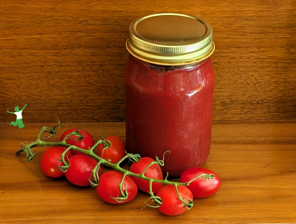 sugar-free fermented ketchup in pint mason jar with on the vine ripe tomatoes