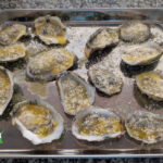 garlic parmesan broiled oysters on the half shell in baking pan
