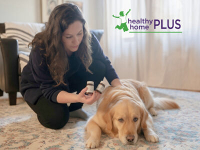 woman giving her dog homeopathic pellets