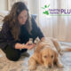 woman giving her dog homeopathic pellets