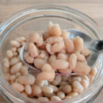 white natto in glass jar with spoon